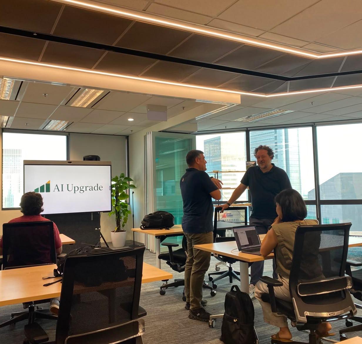 Two members of the first AI Upgrade cohort talking between sessions