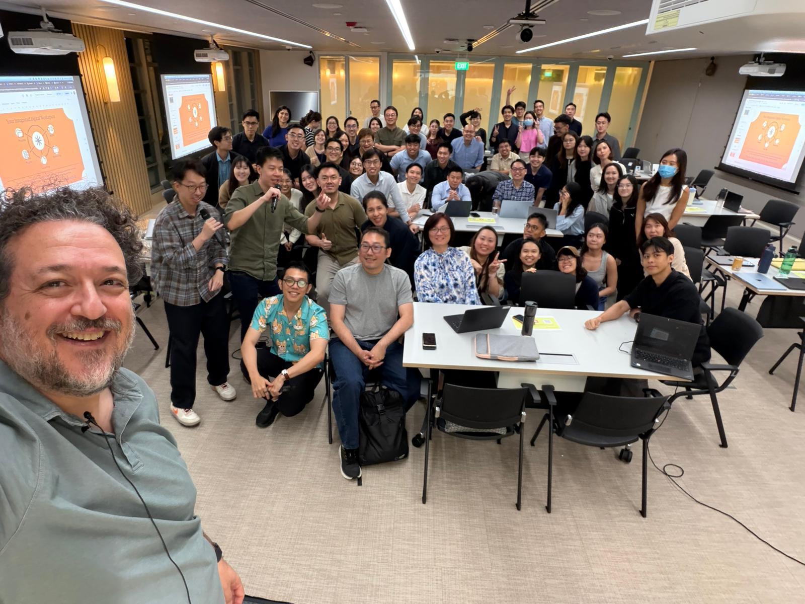 Max Del Vita taking a selfie with a packed Claude Singapore Workshop audience