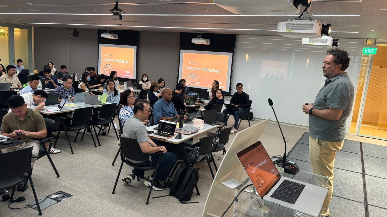 Max Del Vita presenting the Claude Singapore Workshop to a full corporate classroom
